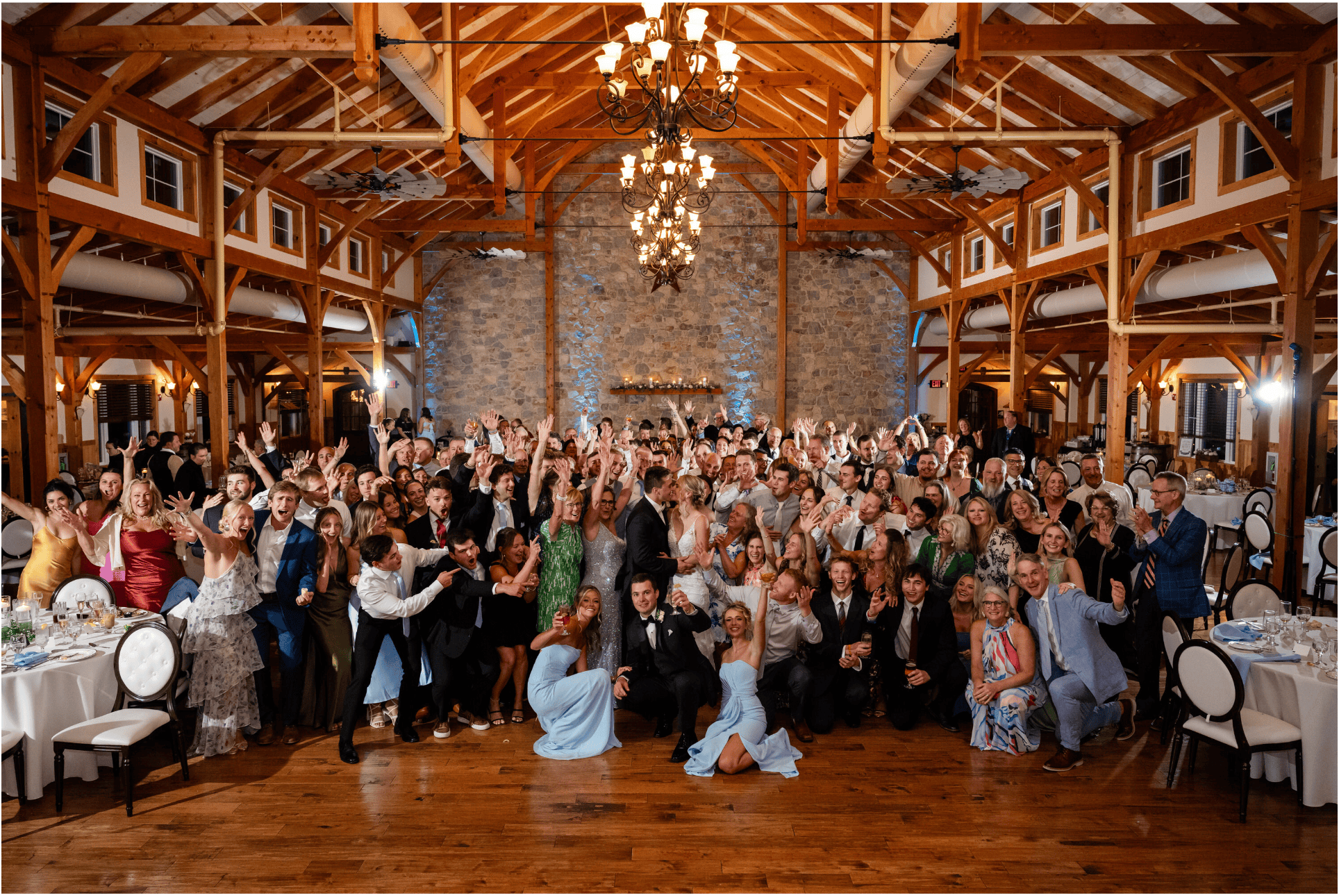 Full wedding party and guests gathered on the Country Barn dance floor